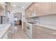Bright kitchen with white appliances, ample counter space, and an open view into the living area at 6025 Shore S Blvd # 408, Gulfport, FL 33707