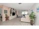 Inviting living room with neutral decor, a built-in entertainment unit, and updated flooring at 6025 Shore S Blvd # 408, Gulfport, FL 33707