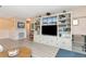 Bright living room featuring a large built-in entertainment center with shelves and cabinets at 6025 Shore S Blvd # 408, Gulfport, FL 33707