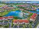 Stunning aerial shot of villas, a lake with fountain, and a golf course in the background at 6080 Bahia Del Mar Cir # 109, St Petersburg, FL 33715