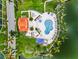 Aerial view of community pool with lounge area and lush landscaping near the water at 6080 Bahia Del Mar Cir # 109, St Petersburg, FL 33715