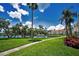 Lush backyard showcasing mature trees, waterfront views, and walkway through the property at 6080 Bahia Del Mar Cir # 109, St Petersburg, FL 33715