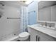 Bright bathroom featuring white tile, white cabinets, a shower, and a marble countertop at 6080 Bahia Del Mar Cir # 109, St Petersburg, FL 33715