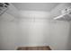 Walk-in closet with wire shelving and wood-look flooring offers ample storage space at 6080 Bahia Del Mar Cir # 109, St Petersburg, FL 33715
