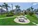 Beautifully landscaped grounds with a stone picnic table and swaying palm trees at 6080 Bahia Del Mar Cir # 109, St Petersburg, FL 33715