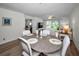 Cozy living room area with wood floors, dining table and chairs, ceiling fan, artwork and comfortable furniture at 6080 Bahia Del Mar Cir # 109, St Petersburg, FL 33715