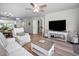 Bright living room featuring coastal decor, neutral walls, and new light wood flooring at 6080 Bahia Del Mar Cir # 109, St Petersburg, FL 33715