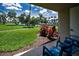 Relaxing patio with seating area overlooking manicured lawn and tranquil waterfront view at 6080 Bahia Del Mar Cir # 109, St Petersburg, FL 33715