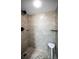 Modern shower features neutral stone-look tile, black hardware, a built-in niche, and a convenient stool at 6080 Bahia Del Mar Cir # 109, St Petersburg, FL 33715