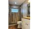Stylish bathroom featuring a walk-in shower with wood-look tile and granite vanity at 6383 Biscayne, North Port, FL 34287