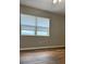 Bright bedroom with a large window and wood-look flooring, offering a serene atmosphere at 6383 Biscayne, North Port, FL 34287