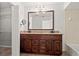 Elegant bathroom featuring a double vanity, granite countertops, and ample storage space at 7021 Blossom Ave, Tampa, FL 33614