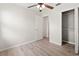 Bedroom featuring laminate flooring, a ceiling fan, a window, and a closet at 7021 Blossom Ave, Tampa, FL 33614