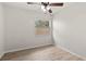 Bedroom showcases laminate flooring, a ceiling fan, and a window providing natural light at 7021 Blossom Ave, Tampa, FL 33614