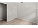 A bright bedroom features neutral walls, laminate flooring, a closet, and a door at 7021 Blossom Ave, Tampa, FL 33614
