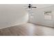 Spacious bedroom featuring hardwood floors and dual windows that provide abundant natural light at 7021 Blossom Ave, Tampa, FL 33614