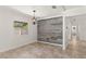 Bright dining room features a decorative wall, window, and access to other rooms at 7021 Blossom Ave, Tampa, FL 33614