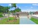 Attractive single-story home boasts a well-maintained lawn, stone accents, and a driveway at 7021 Blossom Ave, Tampa, FL 33614