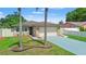 Charming single-story home boasts a stone facade, two-car garage and a lovely driveway at 7021 Blossom Ave, Tampa, FL 33614