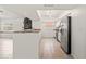Modern kitchen features stainless steel appliances, granite counters, and white cabinetry at 7021 Blossom Ave, Tampa, FL 33614