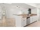 Bright kitchen with granite countertops, white cabinets, and views of the living space at 7021 Blossom Ave, Tampa, FL 33614