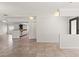 Open-concept living area with tile floors, white walls, and an opening to the kitchen at 7021 Blossom Ave, Tampa, FL 33614