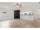 Spacious living room showcasing open floor plan, fireplace, and seamless flow into kitchen at 7021 Blossom Ave, Tampa, FL 33614