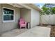 Outdoor patio area featuring white fencing, a chair, and the exterior of the house at 7021 Blossom Ave, Tampa, FL 33614