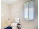 Bright bathroom features walk-in shower and toilet next to a window with blinds at 7061 Denmark St, Englewood, FL 34224