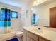 Bathroom with a shower-tub combo and white vanity at 7061 Denmark St, Englewood, FL 34224