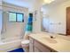 Well-lit bathroom featuring a shower-tub combination and a modern vanity at 7061 Denmark St, Englewood, FL 34224