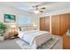 Bright bedroom featuring a large bed, ample closet space, and ceiling fan at 7061 Denmark St, Englewood, FL 34224