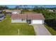 Charming single-story home with a well-manicured front lawn and attached garage at 7061 Denmark St, Englewood, FL 34224