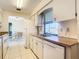 Well-lit kitchen with white appliances and views to dining area at 7061 Denmark St, Englewood, FL 34224