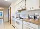 Clean kitchen with white appliances and ample cabinet space at 7061 Denmark St, Englewood, FL 34224