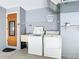 Functional laundry room equipped with a washer, dryer, and utility sink at 7061 Denmark St, Englewood, FL 34224