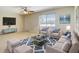 Bright living room features a cozy seating arrangement and large window at 7061 Denmark St, Englewood, FL 34224