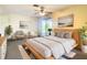 Stylish main bedroom with neutral tones, sliding glass doors, and seating area at 7061 Denmark St, Englewood, FL 34224