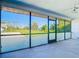 The porch boasts glass windows, offering views of the lush, green back yard at 7061 Denmark St, Englewood, FL 34224