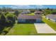 Backyard view shows spacious lawn and rear exterior with a concrete patio at 7061 Denmark St, Englewood, FL 34224