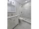 Bathroom features a vanity with marble countertop and a marble tiled shower at 8017 Tudor Pl, Tampa, FL 33610