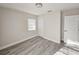 Bright bedroom with neutral walls, gray wood floor, and closet at 8017 Tudor Pl, Tampa, FL 33610