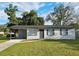 Charming single-story home with a manicured lawn and convenient carport at 8017 Tudor Pl, Tampa, FL 33610