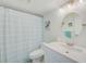 Bright bathroom featuring a tub/shower combo, updated lighting and fixtures at 8211 Brent St # 815, Port Richey, FL 34668