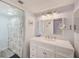 Bright bathroom with a large vanity, framed mirror, modern lighting and a shower/tub combo at 8211 Brent St # 815, Port Richey, FL 34668
