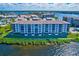 Aerial view of the condo buildings surrounded by lush landscaping and waterways at 8211 Brent St # 815, Port Richey, FL 34668