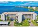 Beautiful waterfront condo complex with manicured landscaping, covered parking, and stunning water views at 8211 Brent St # 815, Port Richey, FL 34668