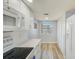 Bright kitchen features white cabinetry, stainless appliances and luxury vinyl plank flooring at 8211 Brent St # 815, Port Richey, FL 34668