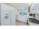 Bright kitchen featuring white appliances, updated countertops, and an open view to the living room at 8211 Brent St # 815, Port Richey, FL 34668