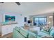 Cozy living room featuring comfortable seating, a water view from the balcony, and coastal-inspired decor at 8211 Brent St # 815, Port Richey, FL 34668
